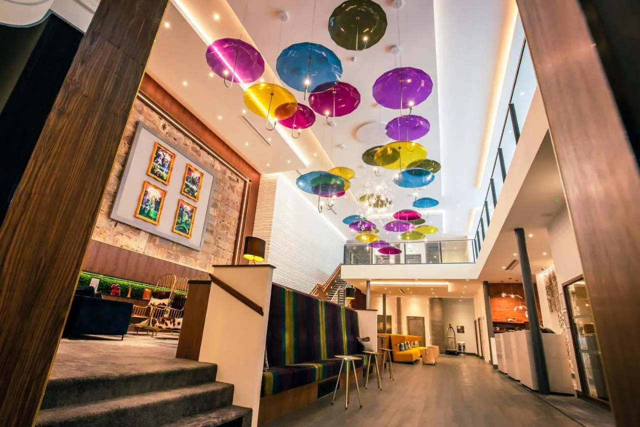 a lobby with colourful umbrellas hanging from the ceiling at Sandman Signature Aberdeen Hotel & Spa in Aberdeen